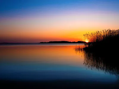 Wandbild und Fototapete mit einem Landschaftsmotiv mit dem Titel Sonnenuntergang am See in der Max Steinwald Art Galerie